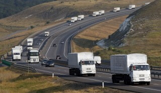 A Russian convoy of trucks carrying humanitarian aid for Ukraine travels along a road south of the city of Voronezh